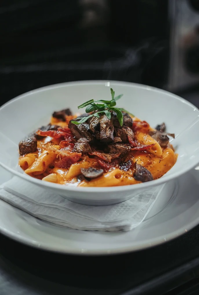 Homemade pasta with crispy bacon and mushrooms